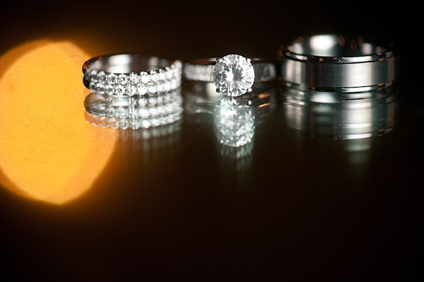 wedding ring display - groom's platinum wedding band and bride's diamond engagement ring and band - photo by Houston based wedding photographer Adam Nyholt